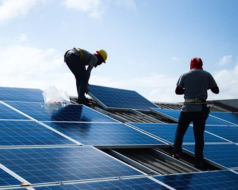 technicians installing solar panels